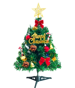 Detailed view of 50cm mini Christmas tree with gold star, red bows and ornaments