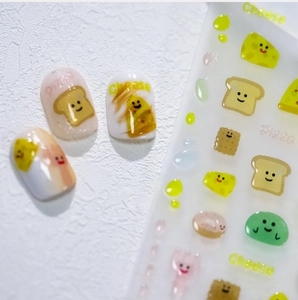Detailed view of 3D cartoon food nail art stickers with cheese and pizza patterns