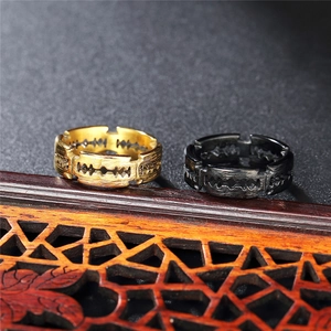 Punk style blade cutout titanium steel rings in gold and black on wooden base