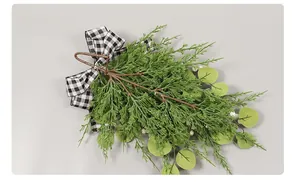 Rear view of eucalyptus Christmas door hanging with pine needles and plaid bow