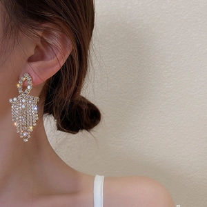 Elegant 925 silver needle tassel earrings with full diamond geometric design on model