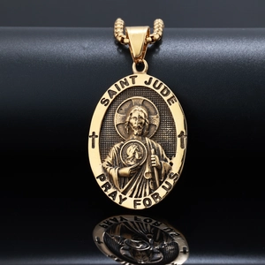 Macro shot of gold Saint Jude oval pendant with detailed relief and polished reflection