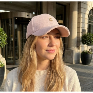 Detail of light pink herringbone wool baseball cap with golden metallic C letter