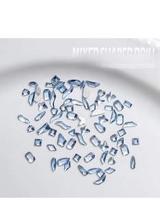 Detailed view of mixed light blue nail art rhinestones with various crystal shapes