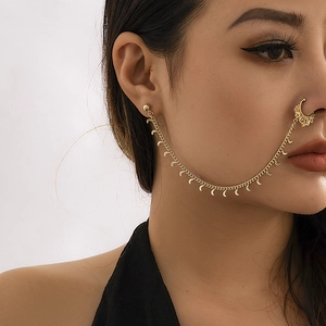 Detailed close-up of golden nose-to-ear chain featuring ethnic crescent moon pendants