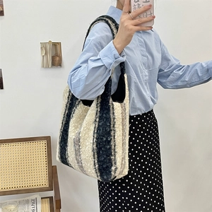 Detailed close-up of a large black and white plush striped tote bag in a casual style