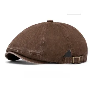 Detail of coffee-colored washed cotton newsboy hat with adjustable vintage metal buckle side