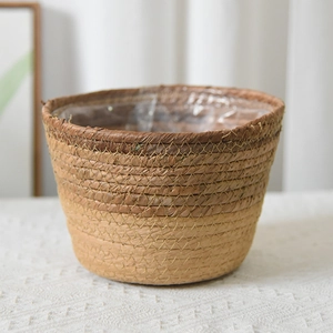 Close-up of seagrass woven basket with two-tone brown design and waterproof plastic liner