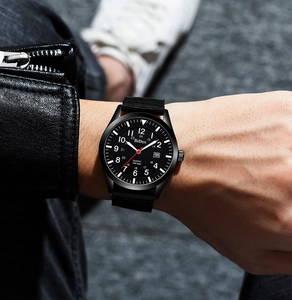 Close-up of military quartz watch on wrist with nylon strap and 50M water resistance