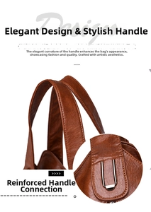 Close-up of reinforced metal hardware and round handles on brown leather tote bag