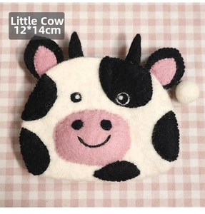 Detailed view of cow shaped wool felt coin purse with dimensions 12x14cm and soft texture