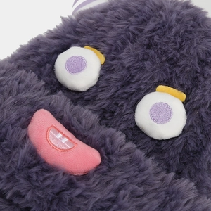 Detail of plush purple monster hat showing soft texture and embroidered funny face