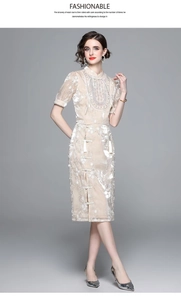 Close-up of champagne satin set featuring floral embroidery with tassels and mandarin collar