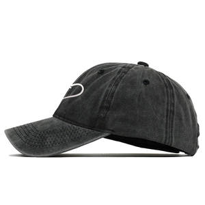 Vintage washed black baseball cap with white heart embroidery from a side view perspective
