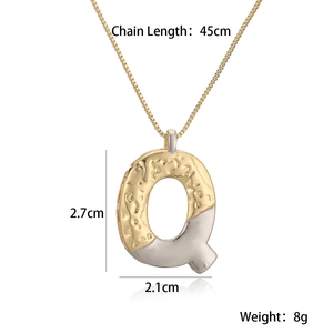 Detail showing two-tone gold and silver letter Q pendant with size measurements