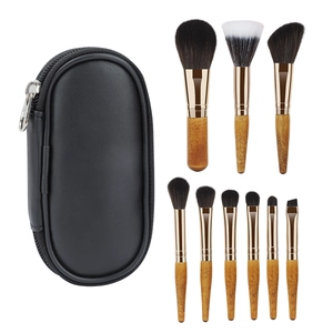9-piece portable makeup brush set with wooden handles and black leather storage case