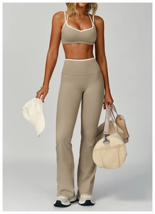 Close-up of khaki flare yoga pants with white contrast piping on high waistband