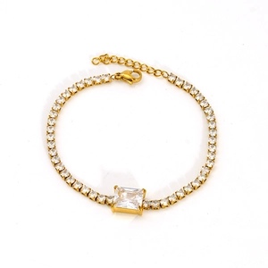 Macro view of gold stainless steel tennis bracelet with rectangular zircon and lobster clasp