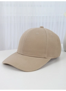 Detail of a minimalist beige cotton baseball cap on a clean white surface