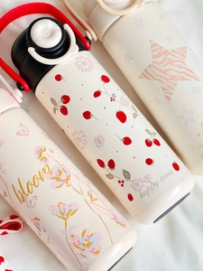 Detail of cute cartoon stainless steel thermos with strawberry pattern and safety lock cap
