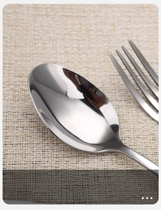 Macro shot of polished stainless steel spoon with smooth edges and mirror finish