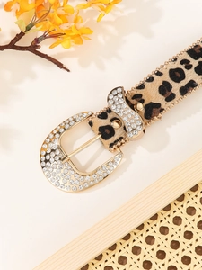 Detail of leopard print belt with rhinestone-studded gold buckle and bead trim