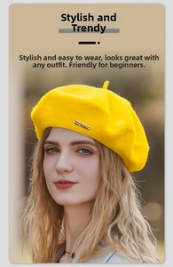 Close-up of yellow wool beret with small metallic buckle and classic top stem detail
