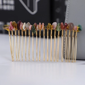 Detail of handmade gold wire hair comb with multi-color natural crystal gravel stones