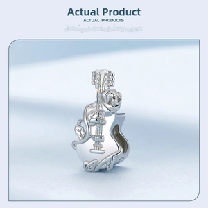 Close-up of S925 sterling silver guitar charm with rose carving and metal hallmark