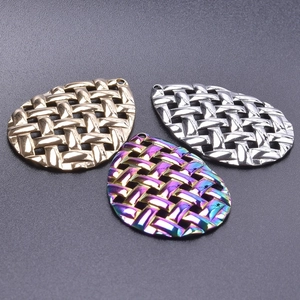 Detailed view of teardrop woven texture pendants in gold, silver, and rainbow steel