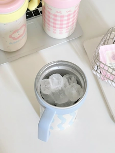 Close-up of blue insulated tumbler filled with ice cubes showing its cooling performance