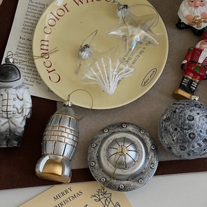 Artistic layout of astronaut and rocket Christmas ornaments on a vintage table setting