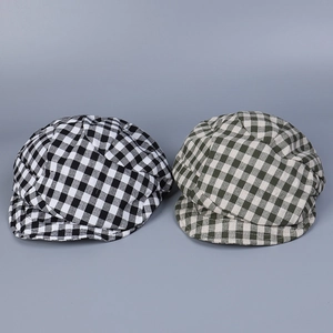 Detail view of vintage plaid linen newsboy caps in black and green checkered patterns