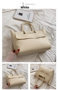 Detail view of large white leather tote bag with unique flap closure for women