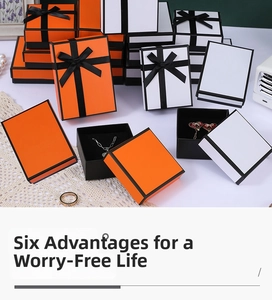 Detailed view of orange jewelry gift boxes with black borders and black flocking liners