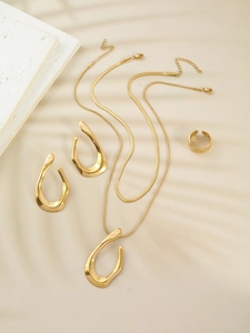 Detail of gold stainless steel set showing double necklace, U-shaped earrings and ring