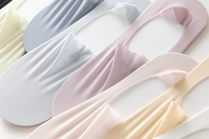 Close-up of lightweight cotton blend no-show socks in various pastel colors arranged neatly