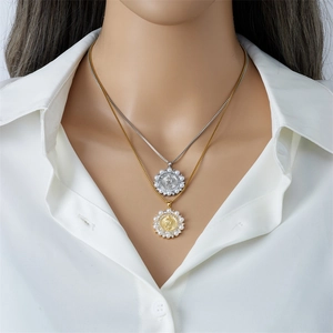 Layered gold and silver necklaces with sunflower religious pendants and pearls on a model