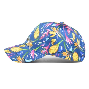 Detail of colorful baseball cap featuring tropical floral print and vibrant butterfly pattern