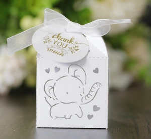 Macro view of white laser-cut elephant candy box with ribbon and thank you tag