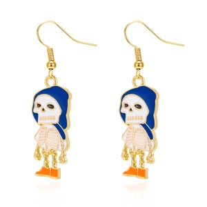Detailed macro of cartoon skull earrings with blue hood and orange shoes on white background