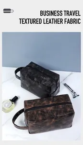 Detail of PU leather toiletry bags in black and dark brown with smooth matte texture