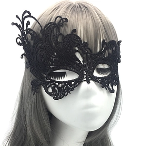 Detailed view of black lace eye mask with intricate floral cutouts on a mannequin head