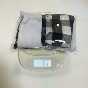 Weight measurement of six small plaid Christmas stockings in packaging on a digital scale