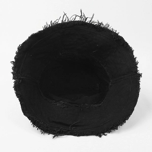 Detail shot of black washed cotton bucket hat showing frayed edges and inner stitching
