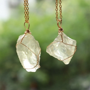 Detailed macro view of handmade wire wrapped natural citrine crystal stone pendant necklaces