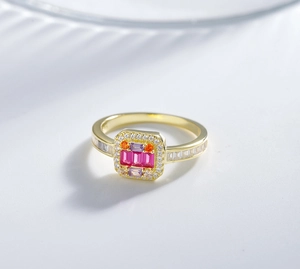 Detail of 14k gold plated silver ring with red gemstones and micro paved white diamonds