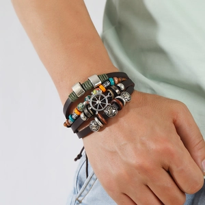 Bohemian multilayer leather bracelet with metal star and rudder charms on wrist