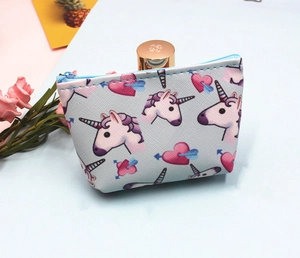 Detail of cross-grain unicorn coin purse with blue zipper and heart patterns