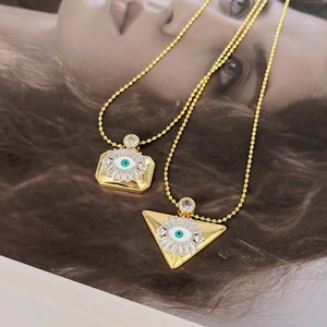 Vintage evil eye pendant necklace with gold square and triangle charms in zircon finish
